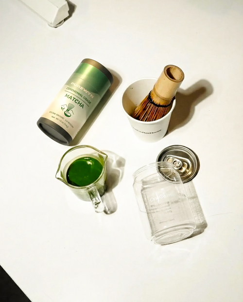 Purewyn ceremonial matcha powder in a bowl with a bamboo whisk, showcasing traditional tea preparation in a serene setting.